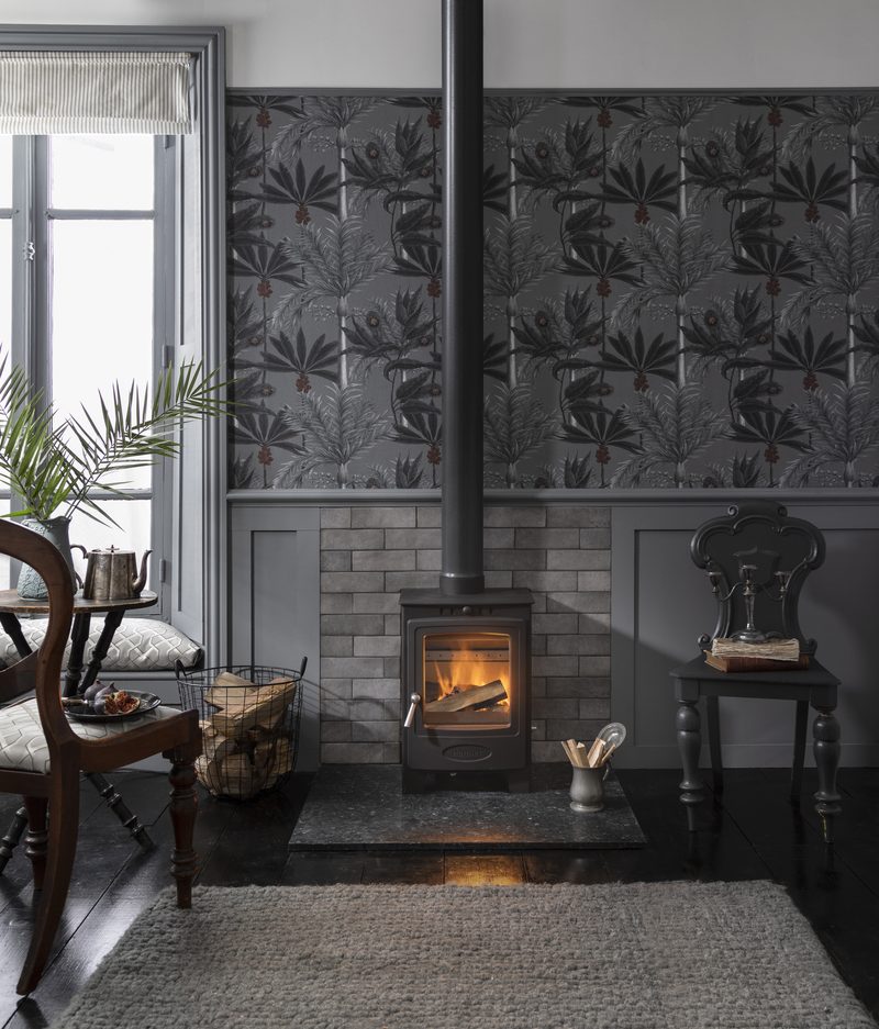 Arada Solution 5 Compact stove with visible flue pipe through tiled chimney breast